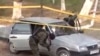 Полицейские осматривают машину на месте теракта. Тараз, 12 ноября 2011 года.
