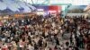 Passengers wait to be checked-in manually at Kuala Lumpur International Airport amid global IT outage, in Sepang