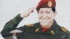 Venezuela -- A woman walks by a graffiti depicting President Hugo Chavez in Caracas, 24Apr2012