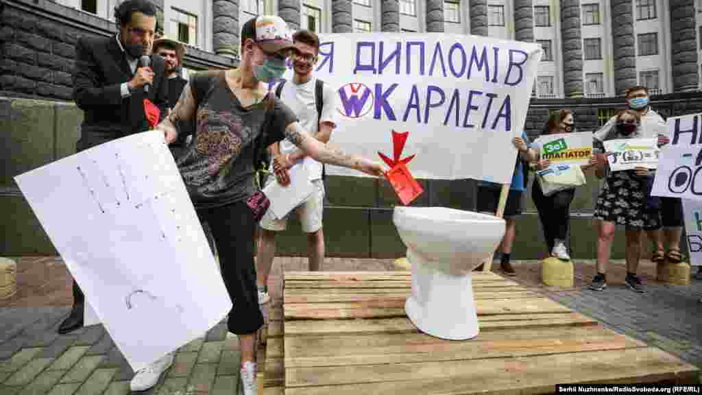 Учасник акції викидає в унітаз «зашкварний диплом» від Шкарлета