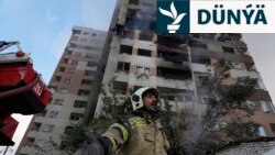 13-nji iýunda Ysraýylyň Eýrana howa hüjümini amala aşyrmagyndan soň, Tähranyň demirgazygyndaky ýaşaýyş jaýda partlamanyň bolan ýerinde işleýän ýangyn söndürijiler.