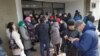 Люди стоят в очереди, чтобы получить пропуск на передвижение по городу. Семей, 2 апреля 2020 года.