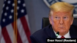 U.S. -- U.S. President Donald Trump attends a teleconference with governors to discuss partnerships to ?prepare, mitigate and respond to COVID-19" at the headquarters of the Federal Emergency Management Agency (FEMA) amid coronavirus fears, in Washington,