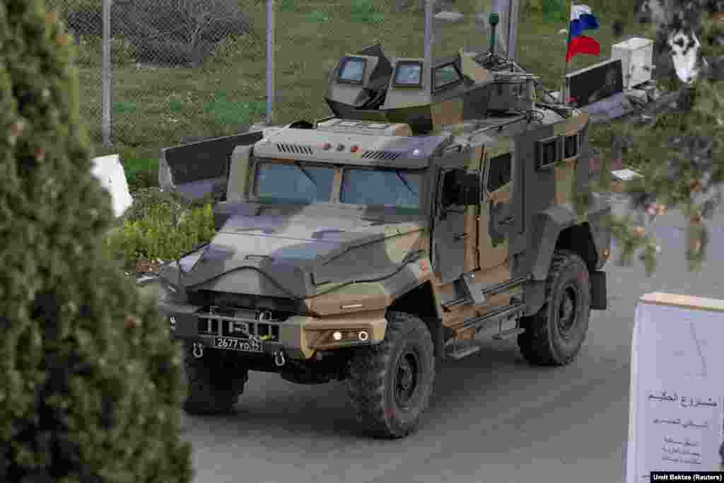Російський бронетранспортер прибуває на авіабазу&nbsp;Хмеймім. &laquo;Цікаво бути там без будь-якого контролю, без будь-якого тиску&raquo;, &ndash; каже Бектас.&nbsp;Перед початком роботи, фотограф поговорив з повстанцями поблизу бази, щоб попередити їх про свою присутність. &laquo;Ти знаходиш відносно високу будівлю, стоїш там чотири години і фотографуєш. Те, що було неможливим, тепер стало реальним&raquo;, &ndash; розповів він &nbsp;